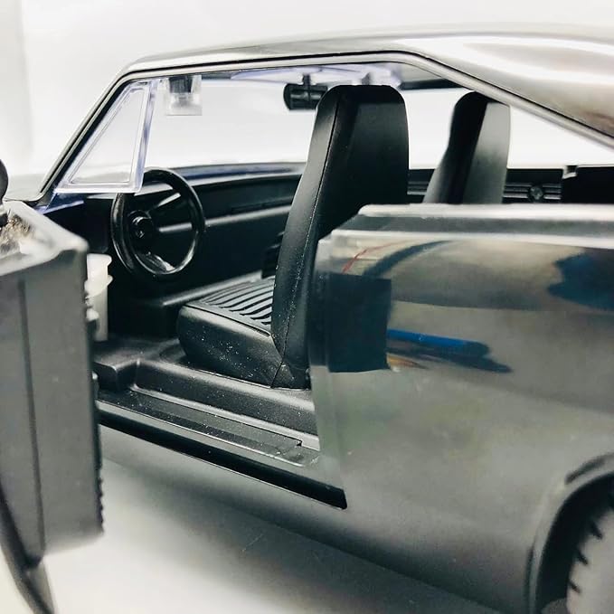 Close-up of a model car interior with steering wheel and dashboard.
